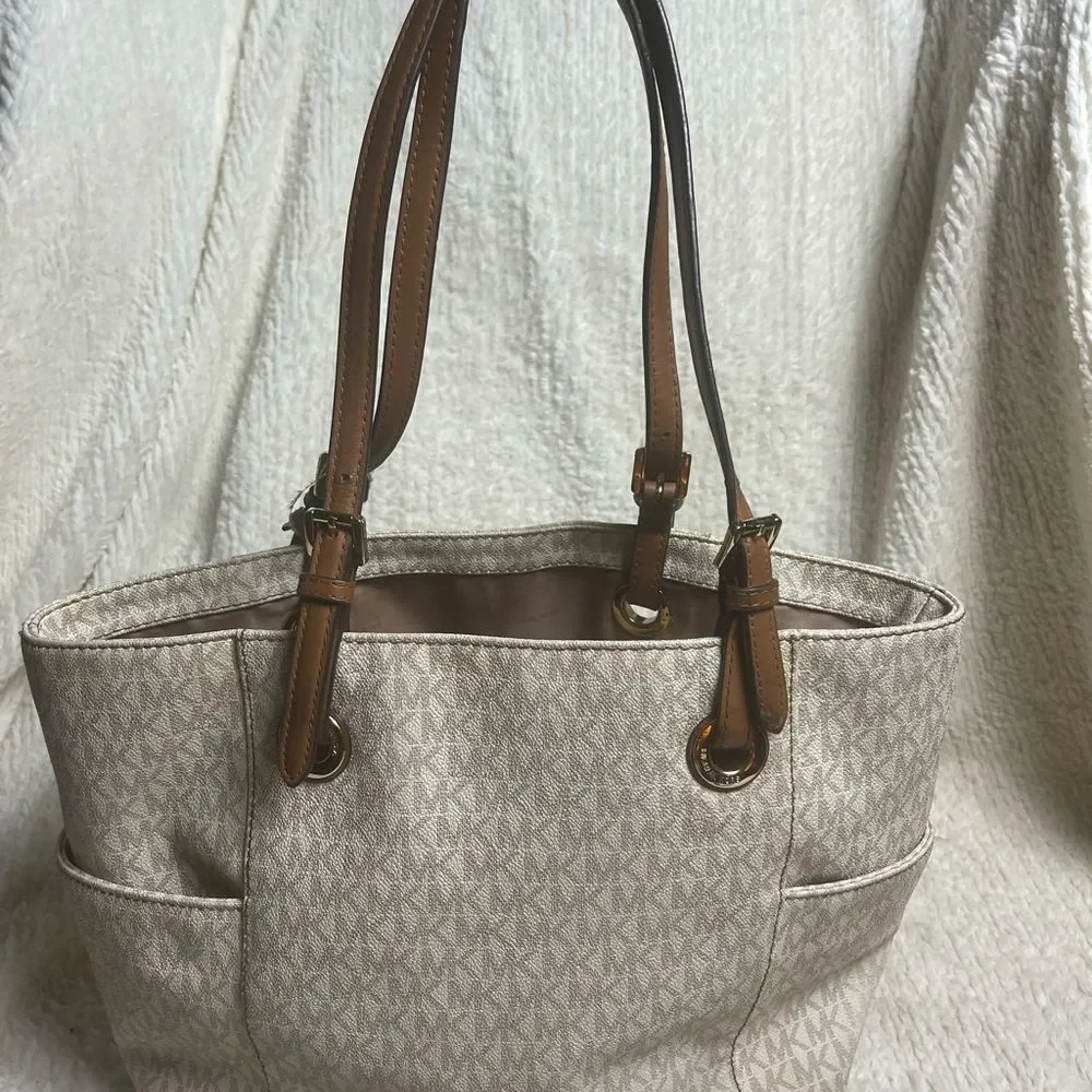 Michael Kors Beige signature Coated Canvas tote , tan leather straps .
